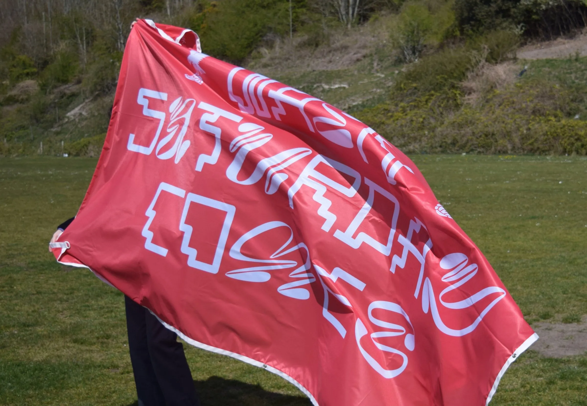Red flag with white lettering