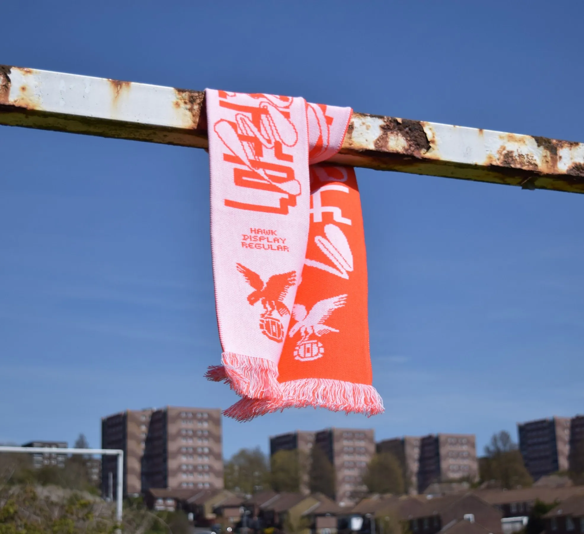 Red and white scarf hanging from a goalpost