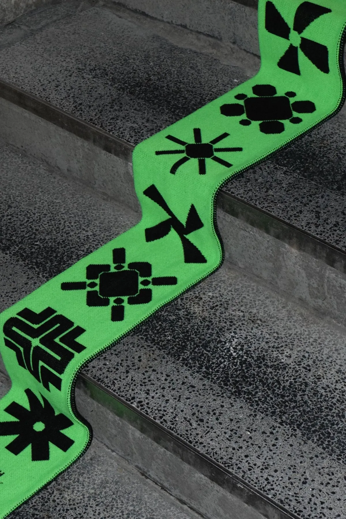 Green patterned scarf on concrete steps